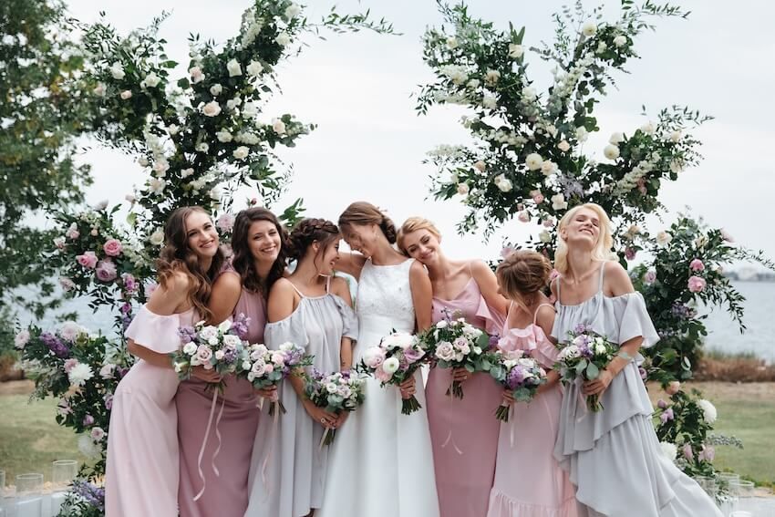 Summer wedding colors: bridesmaids posing at the camera