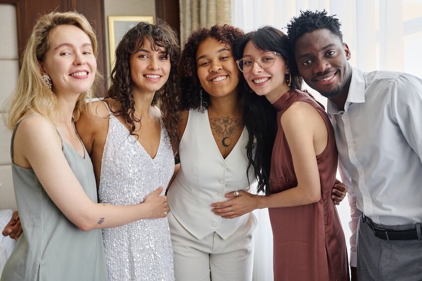What to wear to a wedding: group of people smiling at the camera